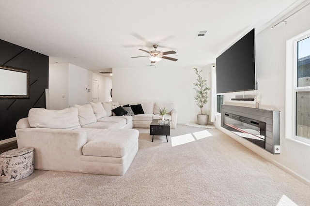 carpeted living room featuring ceiling fan and visible vents