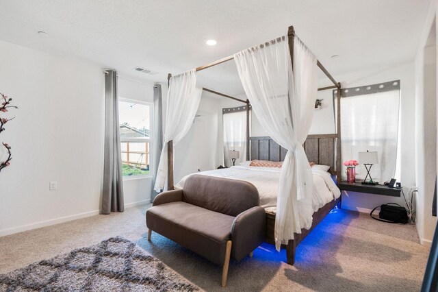 bedroom featuring carpet, visible vents, and baseboards