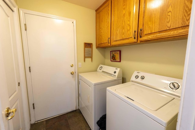 washroom with cabinet space and washer and dryer