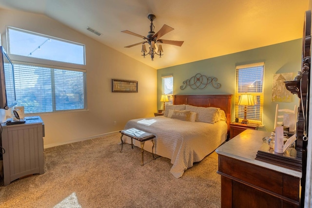 carpeted bedroom featuring lofted ceiling, baseboards, visible vents, and a ceiling fan