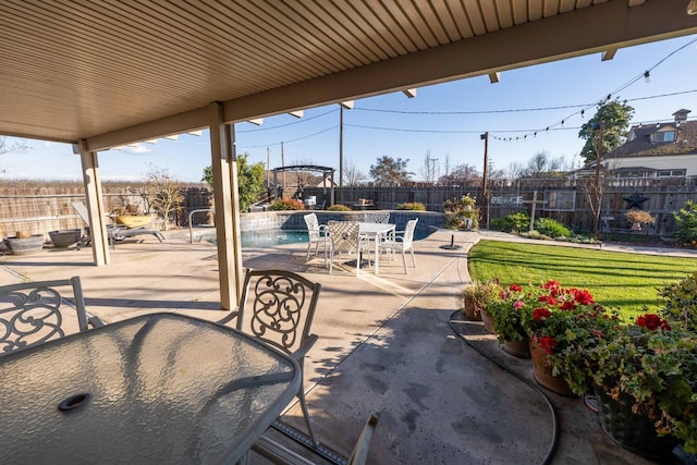 view of patio / terrace with a fenced in pool, outdoor dining area, and a fenced backyard