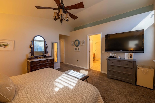 carpeted bedroom featuring a ceiling fan, lofted ceiling, baseboards, and ensuite bathroom