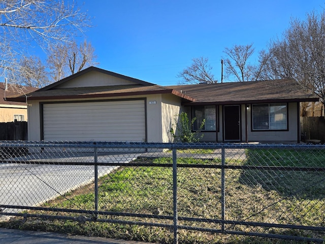 view of front of property with an attached garage and a fenced front yard