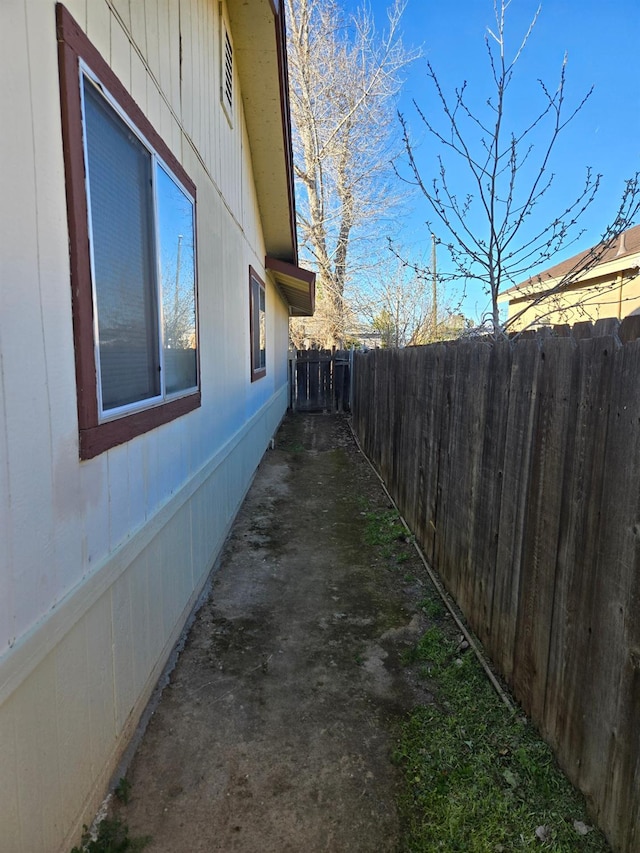 view of side of home featuring fence