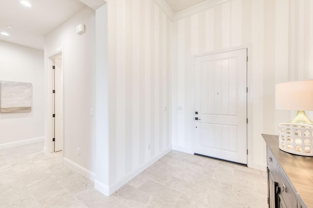 entrance foyer featuring wallpapered walls, baseboards, ornamental molding, and recessed lighting