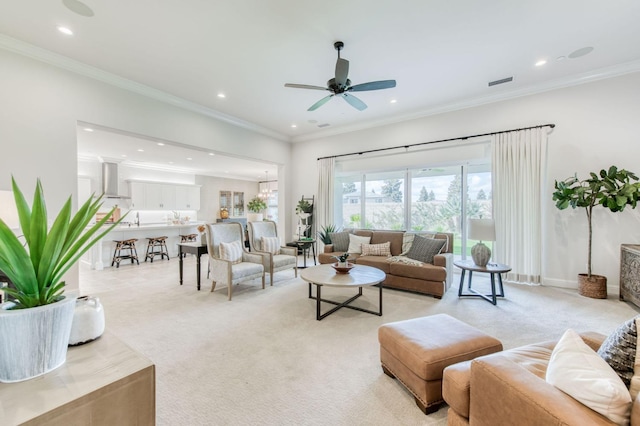 living area with crown molding, recessed lighting, visible vents, and light colored carpet