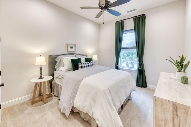 bedroom with light carpet, baseboards, visible vents, and a ceiling fan