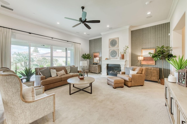 living room featuring ornamental molding, visible vents, a glass covered fireplace, and light colored carpet