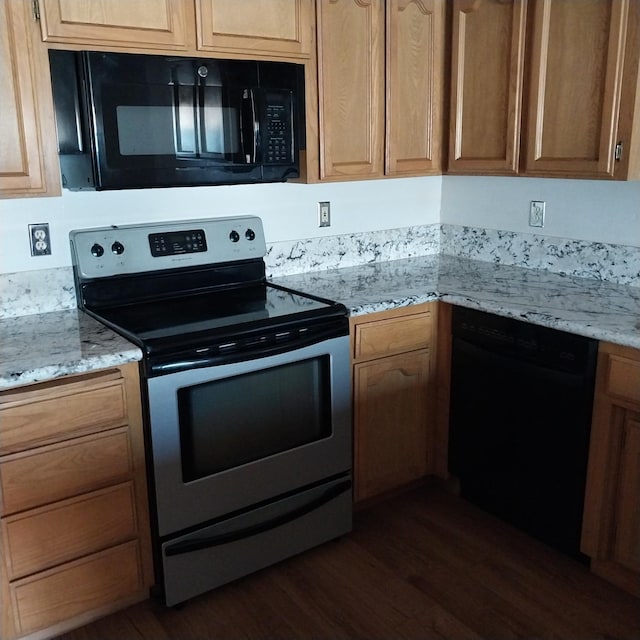 kitchen featuring black appliances, dark wood-style floors, and light stone counters