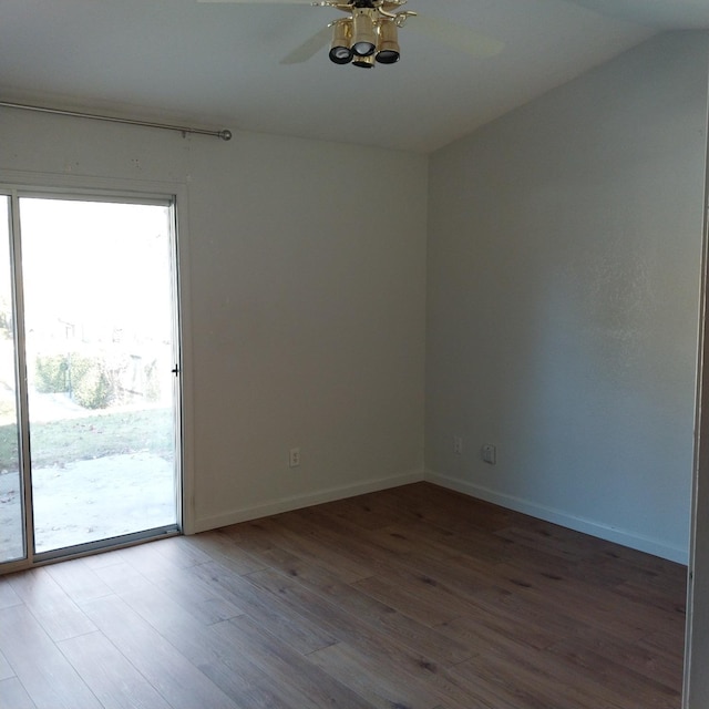 unfurnished room with lofted ceiling, wood finished floors, a ceiling fan, and baseboards