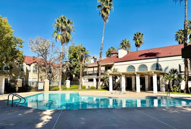 pool featuring a patio area and fence