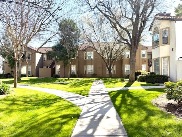 view of community with a residential view and a yard