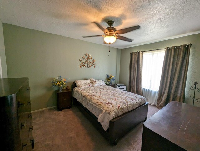 bedroom featuring a ceiling fan, carpet, a textured ceiling, and baseboards