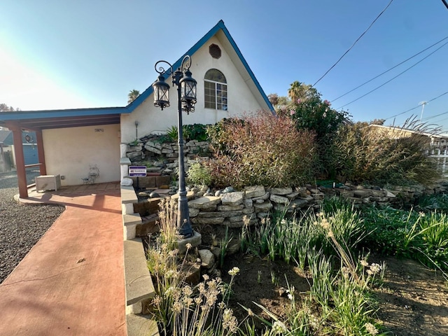 view of front of home featuring a patio and stucco siding