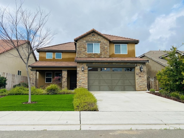 traditional home with an attached garage, fence, concrete driveway, stucco siding, and a front yard