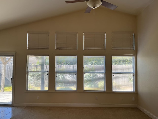 spare room featuring a wealth of natural light, ceiling fan, and vaulted ceiling