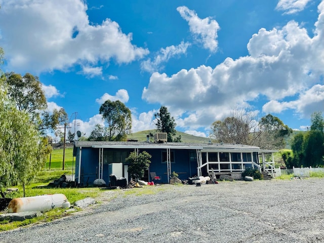 view of front of house featuring cooling unit