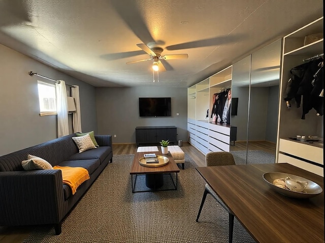 living area with ceiling fan and wood finished floors