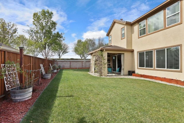 view of yard featuring a fenced backyard and central AC unit