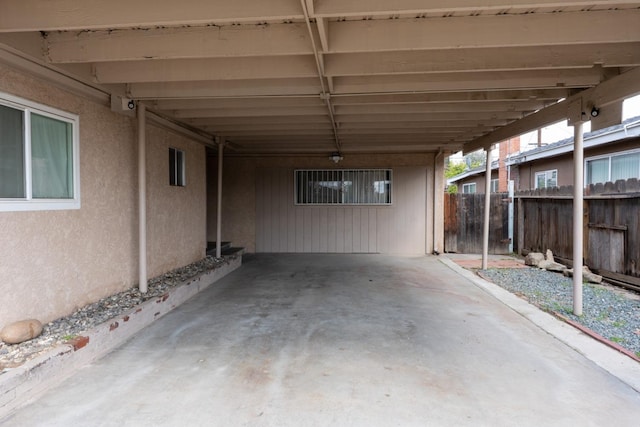 view of patio with a carport and fence