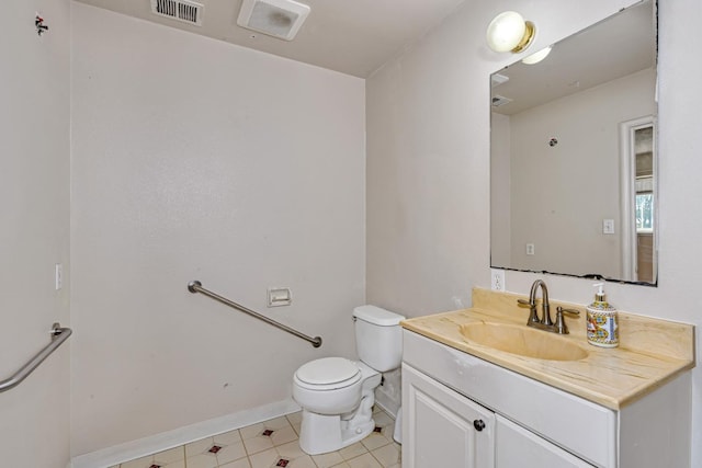 bathroom featuring vanity, toilet, baseboards, and visible vents