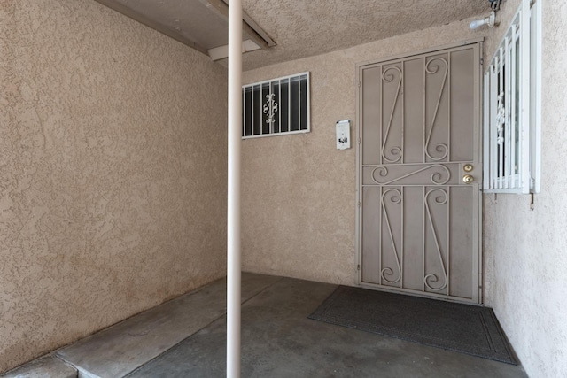 property entrance featuring stucco siding