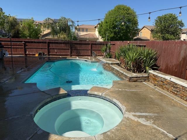 59 Rancho Santa Fe Dr, Madera, CA 93638 - view of pool featuring a fenced backyard, a patio, and a pool with connected hot tub