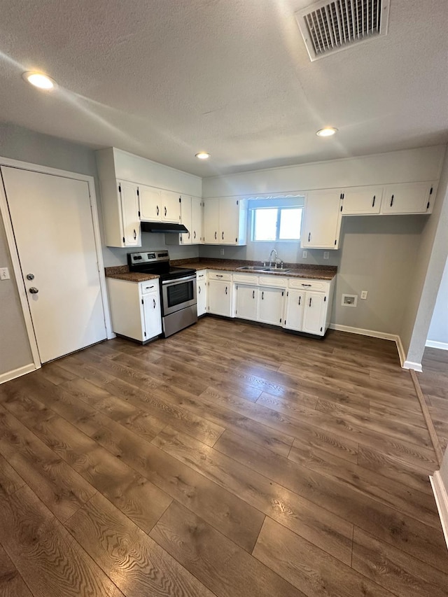 1301 Orange Ave, Chowchilla, CA 93610 - kitchen featuring stainless steel electric range oven, dark countertops, a sink, dark wood-type flooring, and recessed lighting