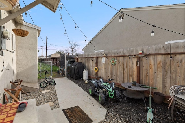 view of patio / terrace with area for grilling and fence