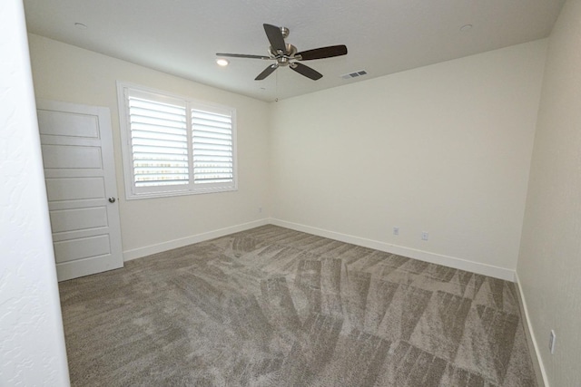 carpeted empty room featuring visible vents, baseboards, and a ceiling fan