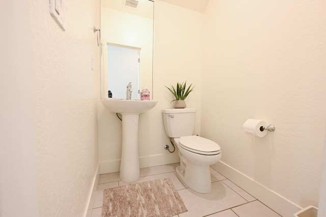 bathroom with tile patterned floors, visible vents, toilet, and baseboards