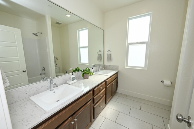 full bath featuring double vanity, toilet, visible vents, and a sink