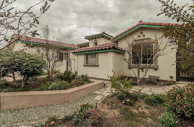 view of front of home featuring a tile roof and stucco siding