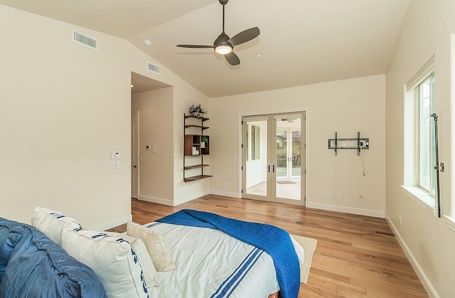 bedroom with visible vents, light wood-style flooring, french doors, and lofted ceiling