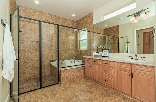 bathroom with visible vents, a stall shower, vanity, and a bath