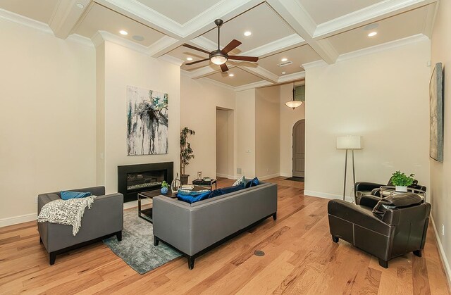 1562 N Empire Ln, Clovis, CA 93619 - living room featuring a ceiling fan, coffered ceiling, beamed ceiling, a glass covered fireplace, and light wood-style floors