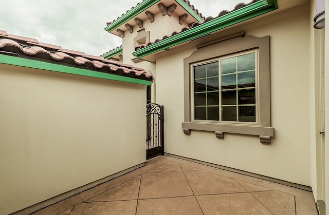 view of property exterior featuring stucco siding and a tiled roof