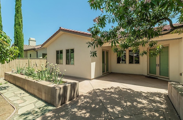 1562 N Empire Ln, Clovis, CA 93619 - back of house with stucco siding, a tile roof, a patio, and french doors