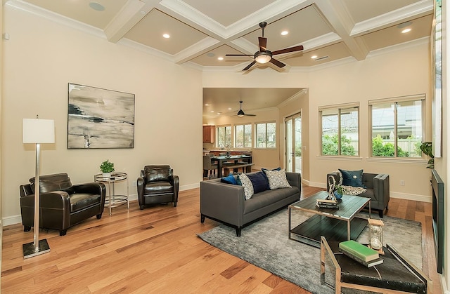 living area featuring beamed ceiling, coffered ceiling, crown molding, and light wood finished floors