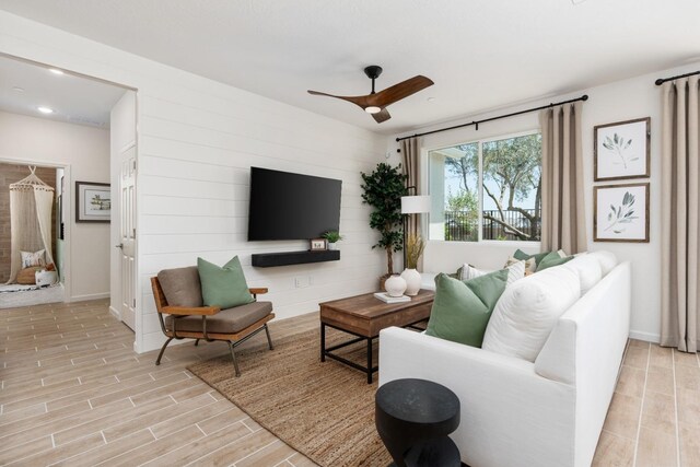 living area featuring baseboards, recessed lighting, a ceiling fan, and wood finish floors