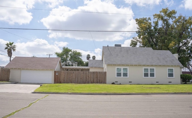 view of home's exterior with fence, roof with shingles, a lawn, a garage, and crawl space