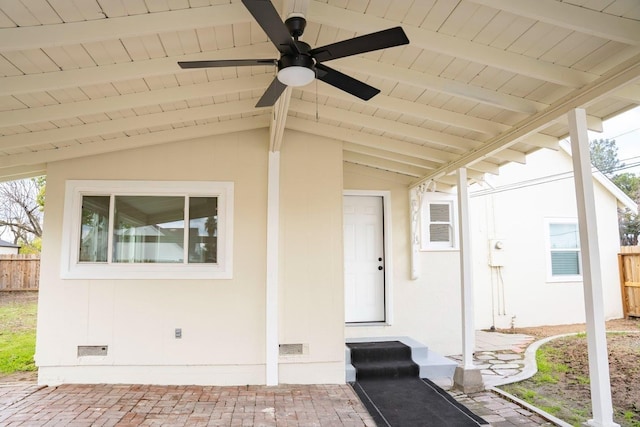 entrance to property featuring crawl space, ceiling fan, and fence