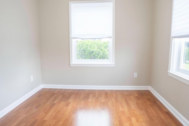 empty room featuring light wood-style floors and baseboards