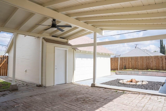 view of patio / terrace with a ceiling fan, fence, and an outdoor fire pit