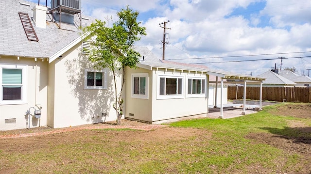 back of house featuring fence, a patio area, stucco siding, a yard, and crawl space