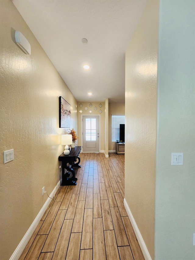 hall with baseboards and wood tiled floor