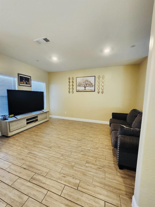 living room featuring visible vents, baseboards, and wood tiled floor