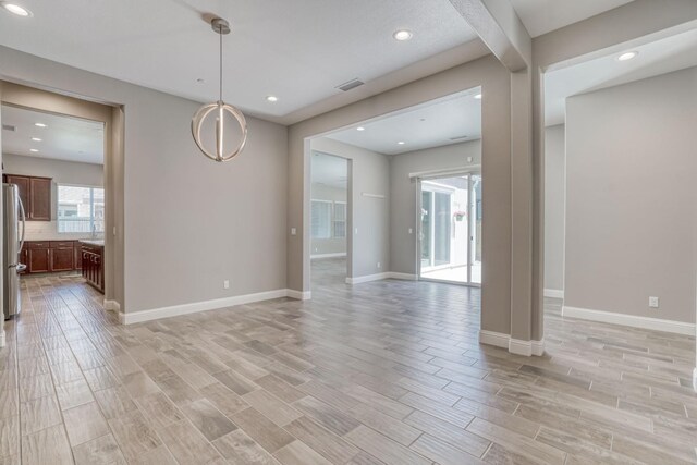 301 Pinnacle Dr W, Madera, CA 93636 - unfurnished room featuring light wood-style floors, baseboards, and recessed lighting
