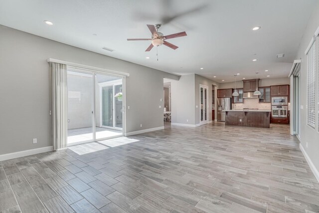 301 Pinnacle Dr W, Madera, CA 93636 - unfurnished living room with ceiling fan, light wood finished floors, baseboards, and recessed lighting