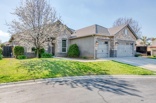 view of front of house featuring fence, concrete driveway, a front yard, a garage, and stone siding